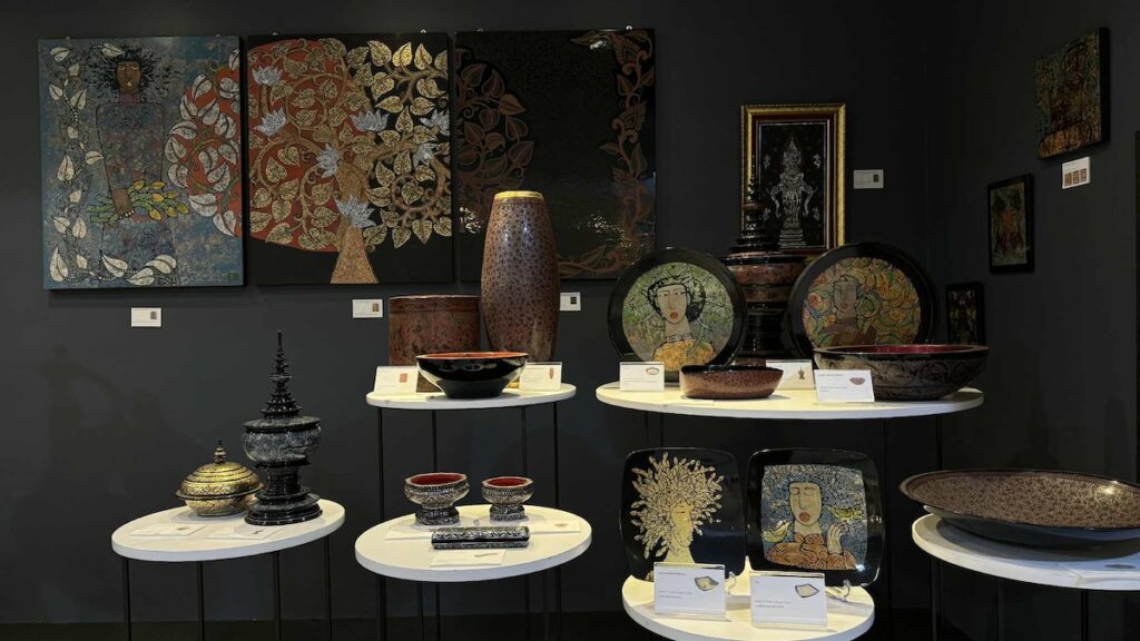 Collection of traditional Thai craftsmanship, featuring lacquerware and painted wooden items, including bowls, vases, and decorative plates."