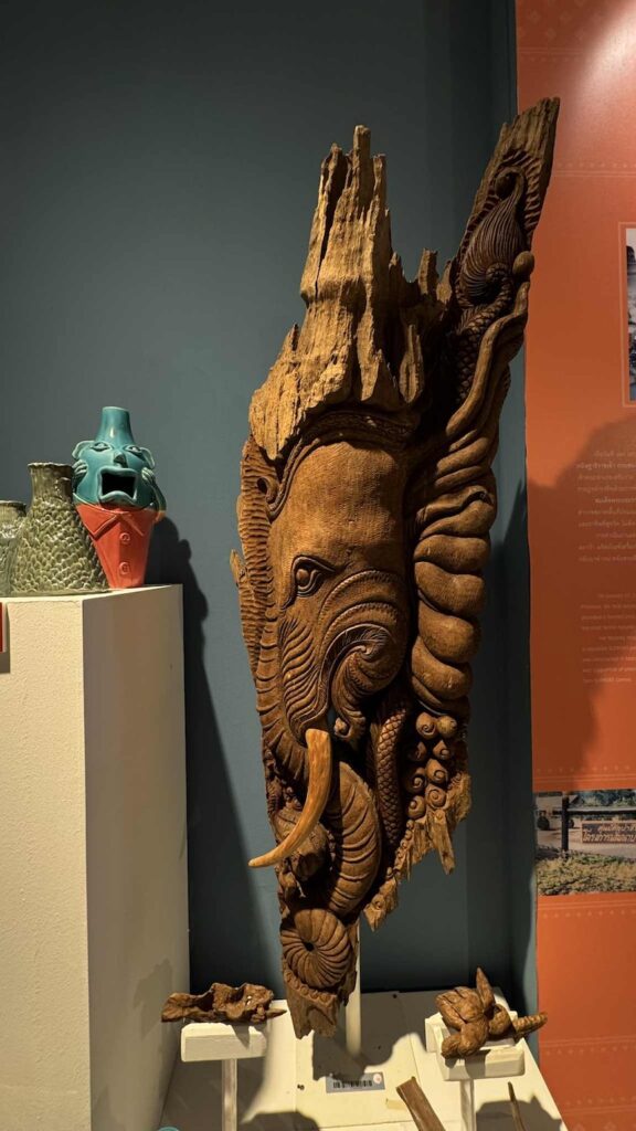 Intricate wood carving of an elephant head, showcasing traditional Thai craftsmanship
