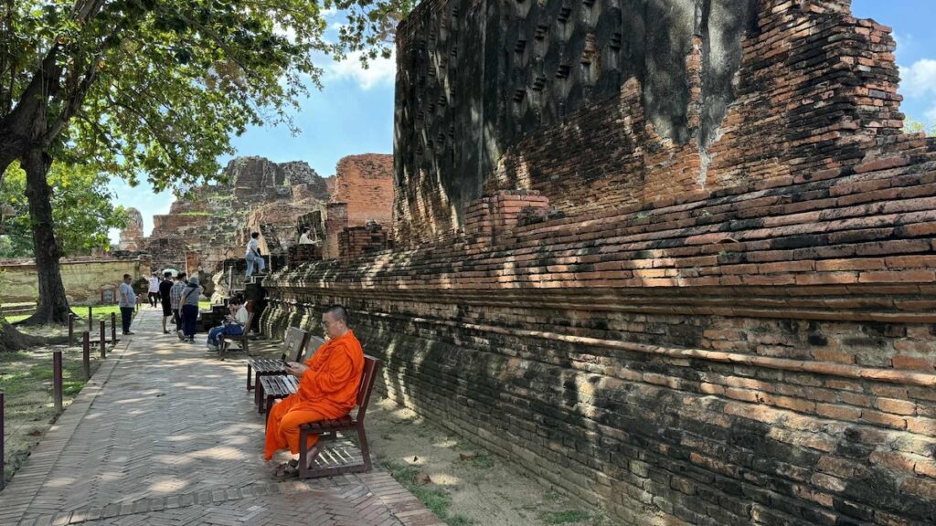 Ruins of Wat Mahathat, a Buddhist temple in Ayutthaya Historical Park, Thailand, with ancient stone structures and remnants of sculptures.